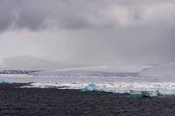 Antarctic landscape with sea and mountains