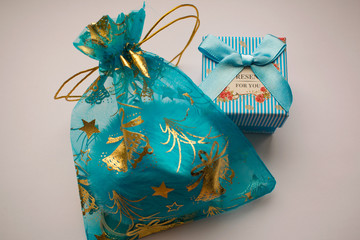 Gifts in a blue box and an organza bag