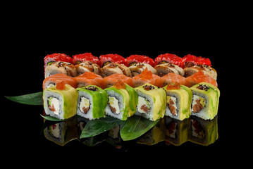 Japanese cuisine. Sushi set over dark background.