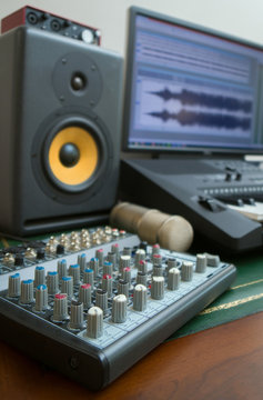 Mixer, condenser microphone and professional monitor. Concept of home music studio.