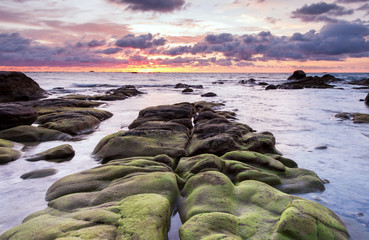 beautiful view of sunset seascape with green moss at Kudat, Sabah Malaysia.