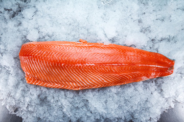 Fresh salmon fillet on ice.