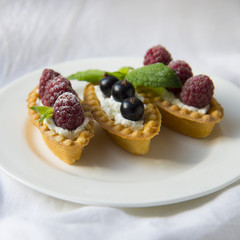 Delicious tartlets with fresh berries and whipped cream