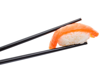 Japanese cuisine. Sushi nigiri in chopsticks isolated on white background background.