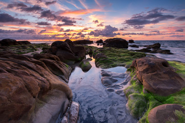 beautiful view of sunset seascape with green moss at Kudat, Sabah Malaysia.