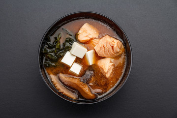 Seafood miso soup over dark table.