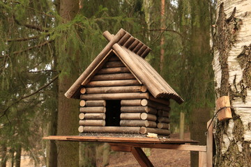 Fototapeta na wymiar Feeding trough for birds, stylized under the house