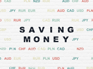 Finance concept: Painted black text Saving Money on White Brick wall background with Currency