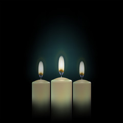 three candles on a black background