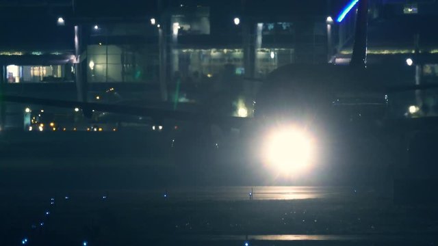 Passenger airplane rides on the runway to take off at night