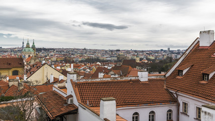 Obraz premium Clouds over the tile roofs of Prague