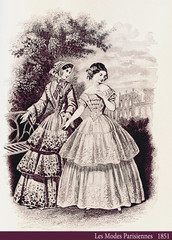 Fototapeta premium 1851 vintage fashion, French magazine Les Modes Parisiennes presents two ladies walking leisurely outdoor in a beautiful garden with fancy cloths and hairdressing
