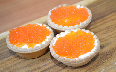 Tartlets with red caviar and butter