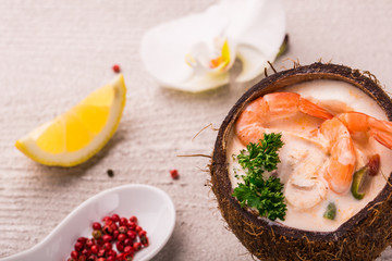 Tasty Shrimp soup with coconut milk, kaffir lime leaves, galangal, chilli and lemon grass in a coconut