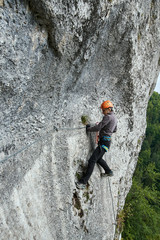 Mountaineer climbing on via ferrata