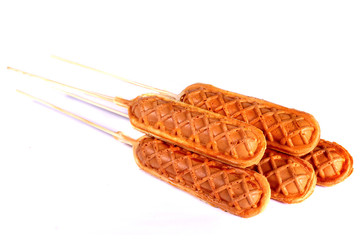 Baked sausages on sticks