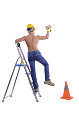 Young male decorator painting with a paint brush.