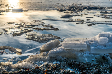 Das Sonnenlicht spiegelt sich auf der eisigen Oberfläche des Sees