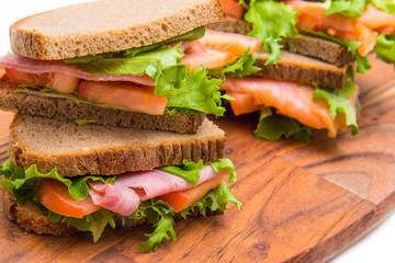 sandwiches with ham and smoked salmon with beer glasses