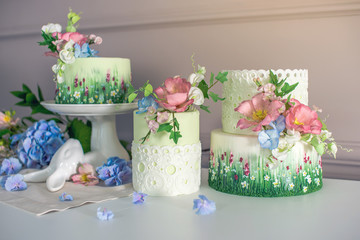 Wedding spring cake decorated with colorful flowers and hydrangeas. Desserts for a festive summer mood
