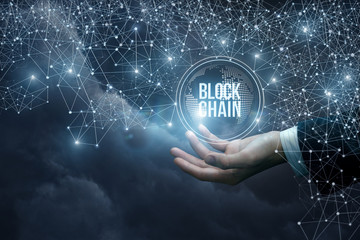 Hand of a businessman in the network shows the block chain .