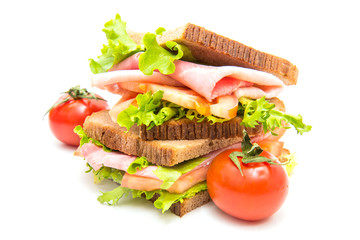 sandwiches with ham, saladf and tomatoes