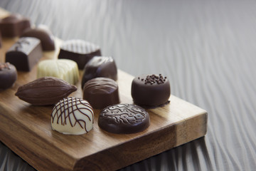 Assorted Chocolates on a Wooden Plank