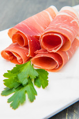marble dish with raw ham slices
