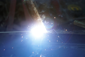 Strong light from the flare of an electric welding. 