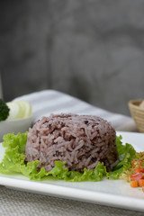 Rice berry is a popular healthy food on white plate
