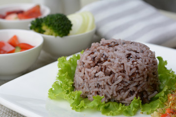 Rice berry is a popular healthy food on white plate