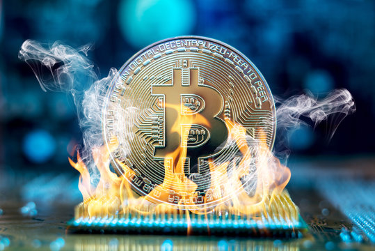Bitcoin cryptocurrency in the form of a coin burns on fire on a microchip. Concept of death blockchain