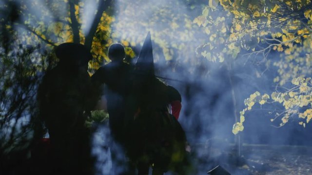 Children walking in foggy woods at night wearing costumes on Halloween / Cedar Hills, Utah, United States