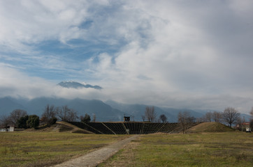 Fototapeta premium View of Hellenistic Theater at the Archaeological Park of Dion with Olympus mount at background. Pieria, Macedonia, Greece