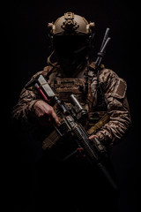 Special forces United States soldier or private military contractor holding rifle. Image on a black background. war, army, weapon, technology and people concept