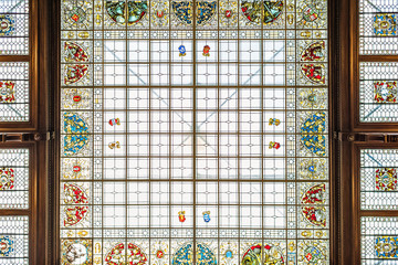 Fototapeta na wymiar Daylight view from bottom to ornamented stained-glass roof in Peles castle