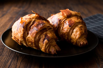 Freshly Baked Croissants on Wooden Surface.