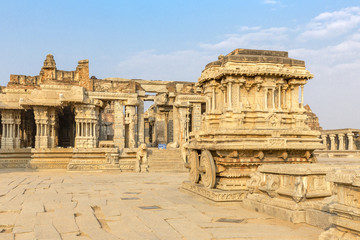 Fototapeta premium Garuda stone chariot and Vitthala temple gopuram, Hampi, Karnataka, India