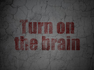 Learning concept: Red Turn On The Brain on grunge textured concrete wall background