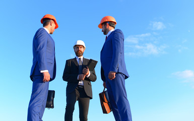 Engineers hold meeting on blue sky background. Board of architects