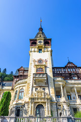 Daylight view from bottom to ornamented facade of Peles castle with tower