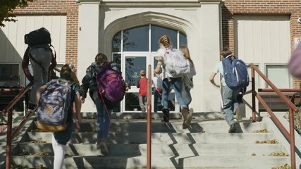 Students arriving at school climbing staircase / Provo, Utah, United States
