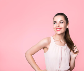 beautiful young woman with long hair posing on background with copy space