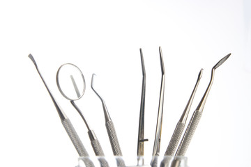 Set of metal dentist's dental medical equipment tools isolated on white background with copy space, close-up