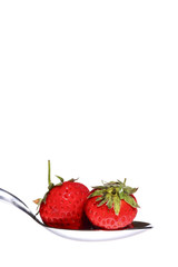 Strawberries on a spoon with a white background