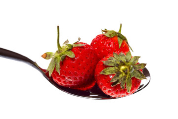 Strawberries on a spoon with a white background