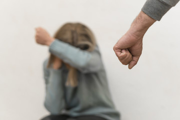 Man beating up his wife illustrating domestic violence