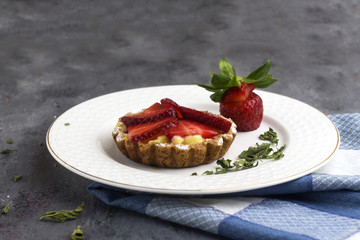 delicious homemade arabic strawberry tartlet on white plate