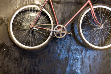 background, lifestyle, country style concept. there is vintage bicycle on the black rough surface, it has clean wheels and pedals, fresh painted frame and cool handlebars