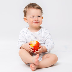 Portrait of a happy little child with an apple in his hands